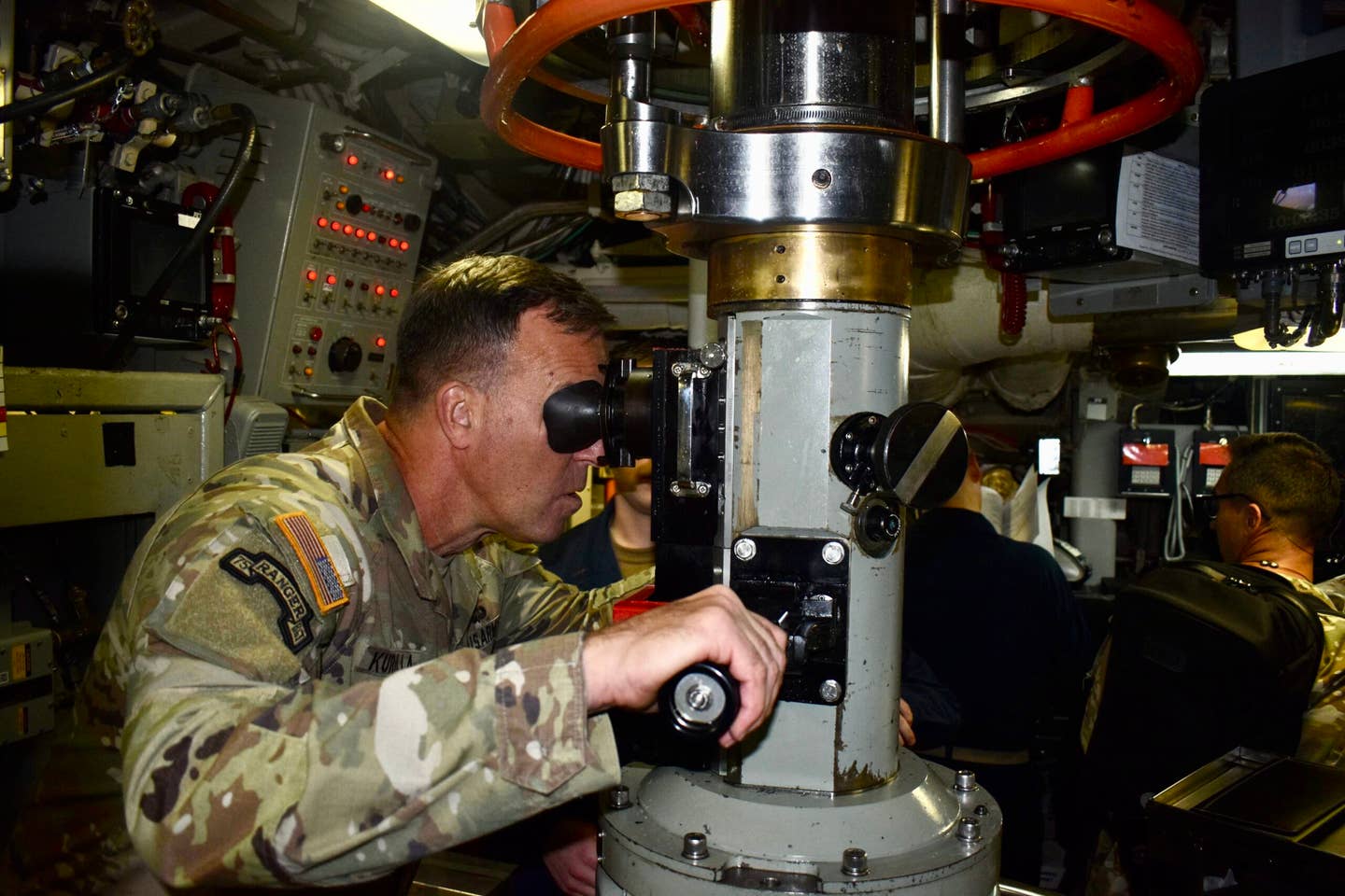 U.S. Army Gen. Michael Kurilla, commander of US Central Command, looks through a periscope during a visit aboard the <em>Ohio</em> class ballistic missile submarine USS <em>West Virginia</em>. <em>CENTCOM</em>
