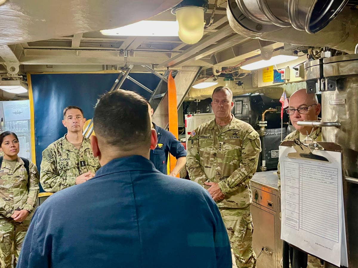 CENTCOM commander Army Gen. Kurilla, second from the right, and U.S. Fifth Fleet/Naval Forces Central Command commander Navy Vice Adm. Brad Cooper, second from the left, among others during the recent visit aboard USS <em>West Virginia</em>. <em>CENTCOM</em>