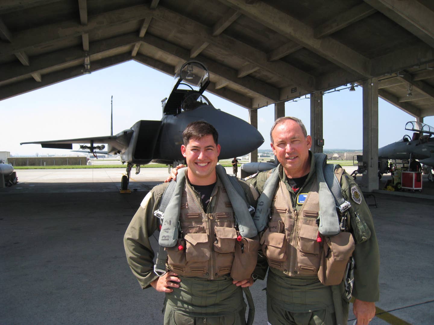 Lt. Gen. David Deptula, then the Air Force deputy chief of staff for intelligence, surveillance and reconnaissance (right), and his son Capt. David Deptula, an F-15 pilot with the 67th Fighter Squadron, prepare for a flight at Kadena Air Base, in 2008. General Deptula himself flew with the 67th FS from 1979 to 1983. <em>U.S. Air Force</em>