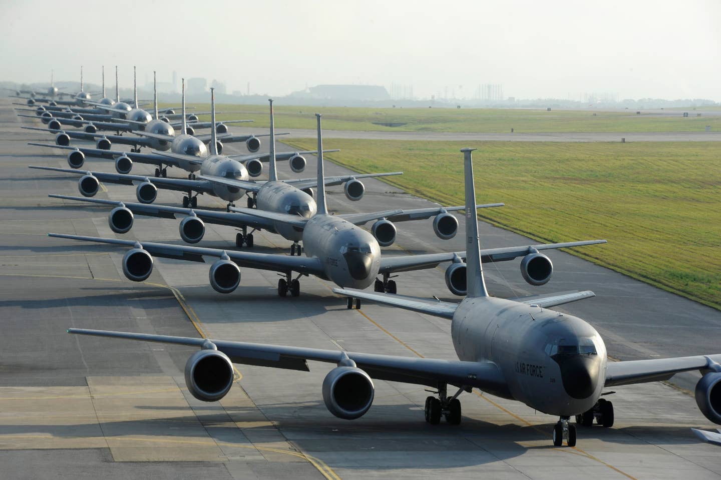 Twelve U.S. Air Force KC-135R Stratotankers from the 909th Air Refueling Squadron taxi onto the runway during an exercise at Kadena Air Base. <em>U.S. Air Force photo by Staff Sgt. Marcus Morris</em>