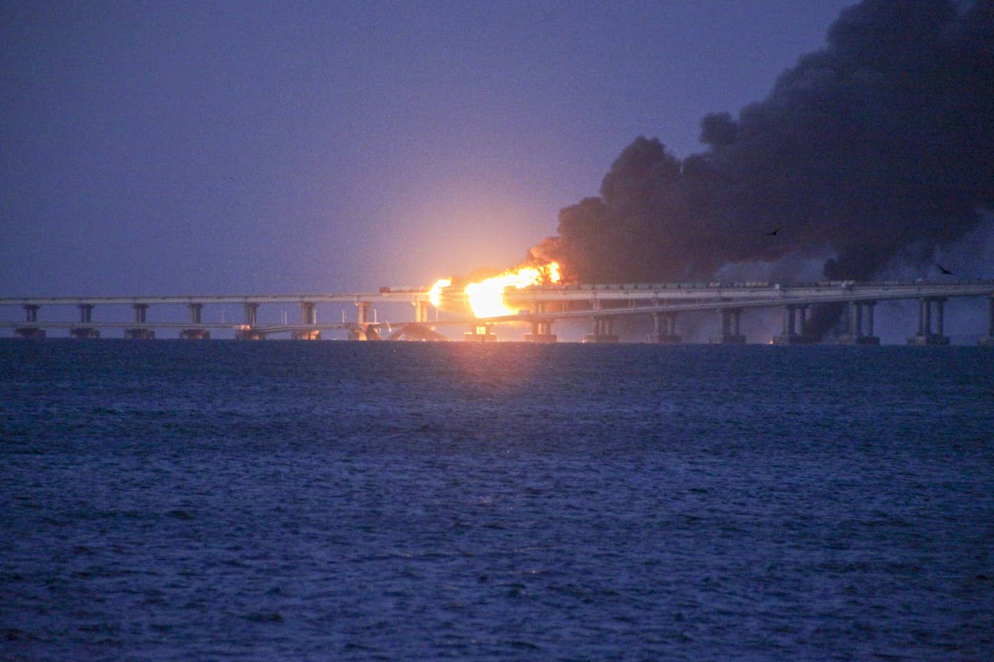 Explosion causes fire at the Kerch bridge in the Kerch Strait, Crimea on Oct. 8. (Photo by Vera Katkova/Anadolu Agency via Getty Images)