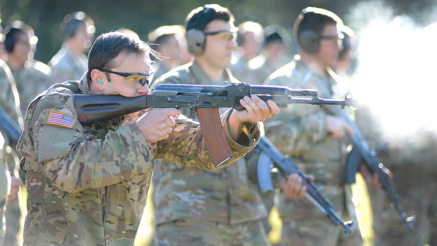 A student assigned to the US Army's John F. Kennedy Special Warfare Center and School (JFKSWCS) fires an AK-74-type rifle during training. <em>US Army</em>