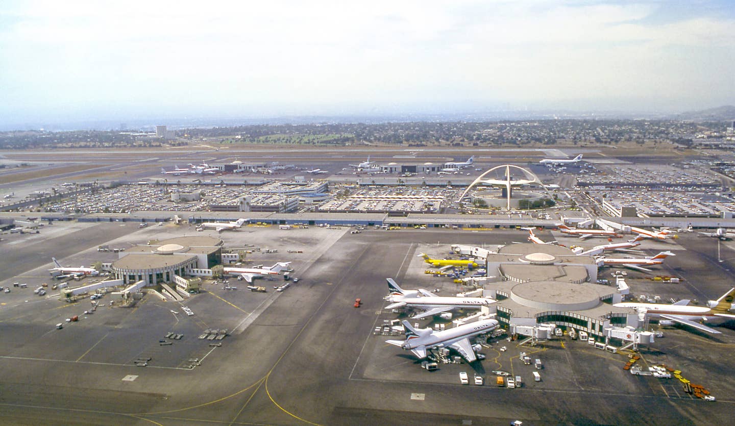 An aerial view of Los Angeles International Airport (LAX) with the Googie architectural style Theme Building right of center. Los Angeles, California, USA. June 1978. Scanned film. <em>Getty Images</em>