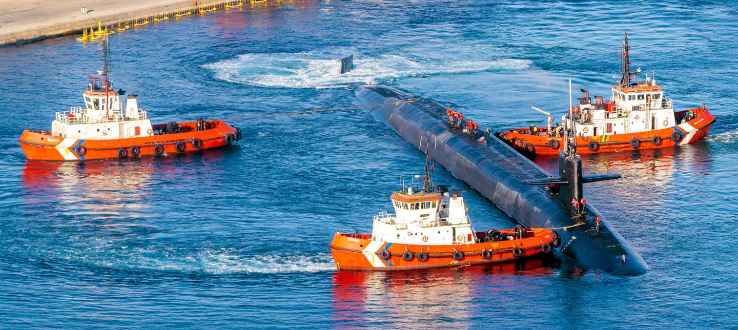 Tugs maneuver <em>Rhode Island</em> to the pier at His Majesty's Naval Base Gibraltar.<em> William Jardim</em>