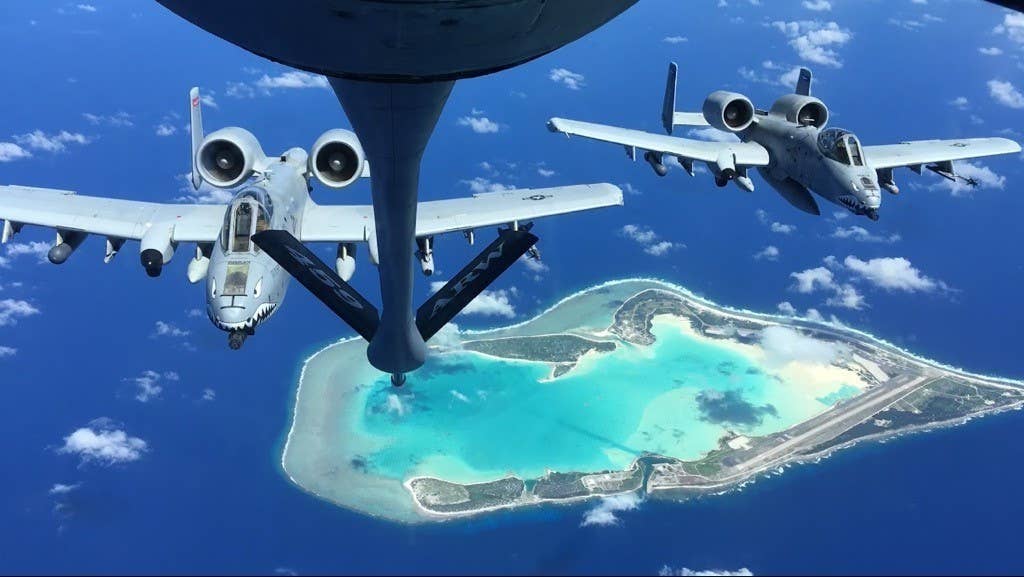 A-10Cs from the 23rd Wing fly behind a KC-135 aerial refueling tanker while passing over Wake Island. <em>USAF</em>