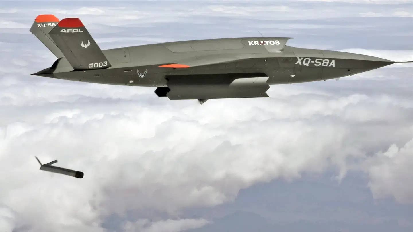 A Kratos XQ-58A Valkyrie, seen here deploying a smaller drone from its ventral payload bay. <em>USAF</em>