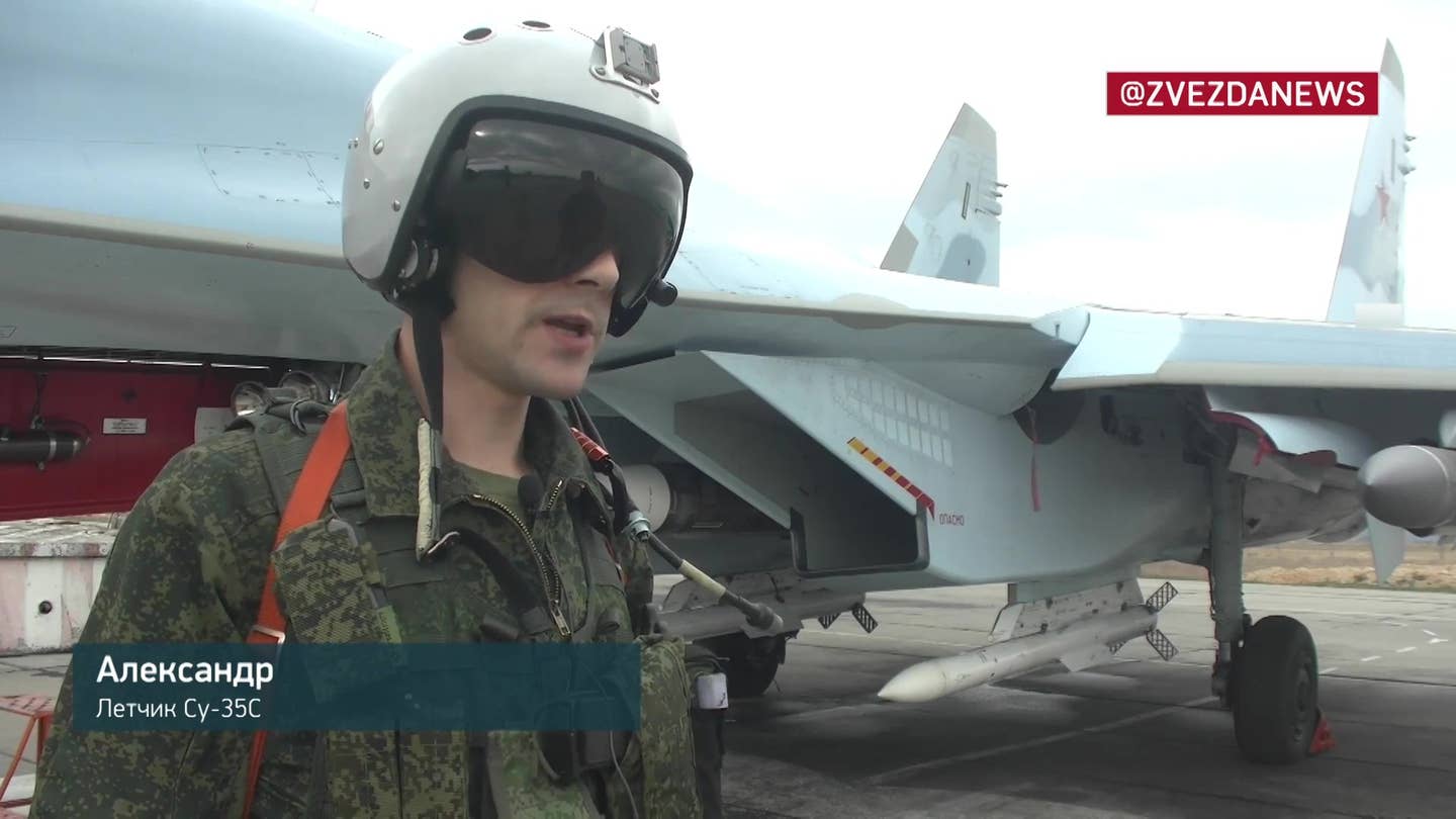 Su-35S pilot Alexander together with a jet armed with R-37M, R-77-1, and Kh-31P missiles, at Belbek, from footage released on November 1, 2022. <em>TV Zvezda</em>