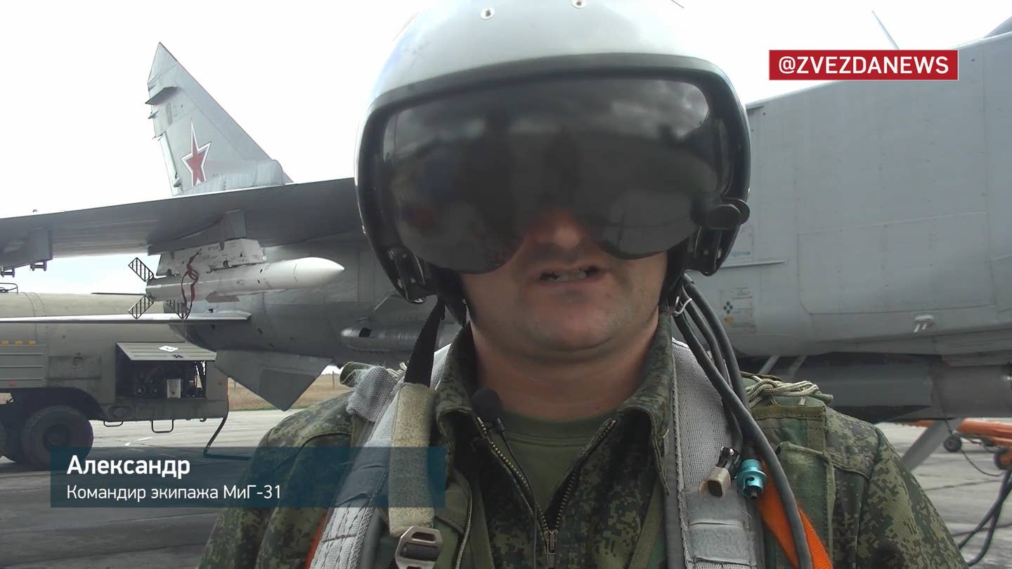 The Foxhound pilot named Alexander, together with a MiG-31BM armed with R-37M, at Belbek, from a video released on October 27, 2022. <em>TV Zvezda</em>