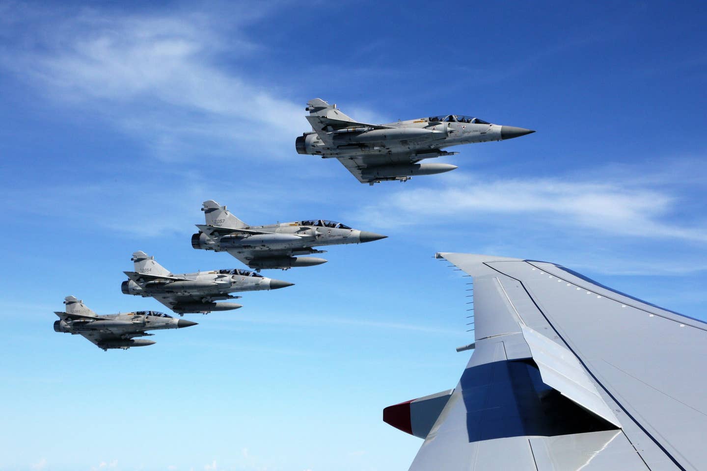Four armed ROCAF Mirage 2000-5 fighter jets escort President Tsai’s plane as she returns from an overseas trip in 2016. <em>Office of the President, Republic of China</em>