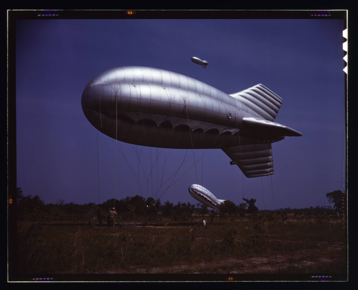 Another example of a World War II-era barrage balloon, this time with its steel cord netting in clear view. (Credit: Palmer, Alfred T./Wikimedia Commons)