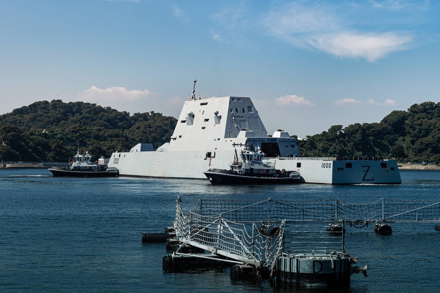 The <em>Valiant</em>-class harbor tugs <em>Puyallup</em> (YT-806) and <em>Menominee</em> (YT-807), assigned to Commander, Fleet Activities Yokosuka (CFAY), escort the <em>Zumwalt</em>-class guided-missile destroyer USS <em>Zumwalt</em> (DDG-1000) to a berth at CFAY for a scheduled port visit. <em>Credit: U.S Navy photo by Seaman Darren Cordoviz</em>