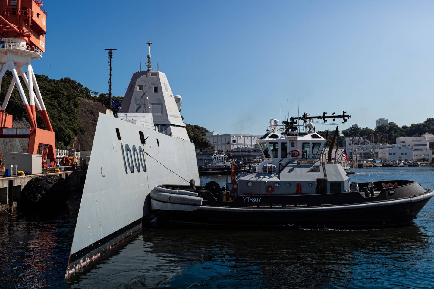 The <em>Valiant</em>-class harbor tugs <em>Puyallup</em> (YT-806) and <em>Menominee</em> (YT-807), assigned to Commander, Fleet Activities Yokosuka (CFAY), escort the <em>Zumwalt</em>-class guided-missile destroyer USS <em>Zumwalt</em> (DDG 1000) to a berth at CFAY for a scheduled port visit. <em>Credit: U.S Navy photo by Seaman Darren Cordoviz</em>