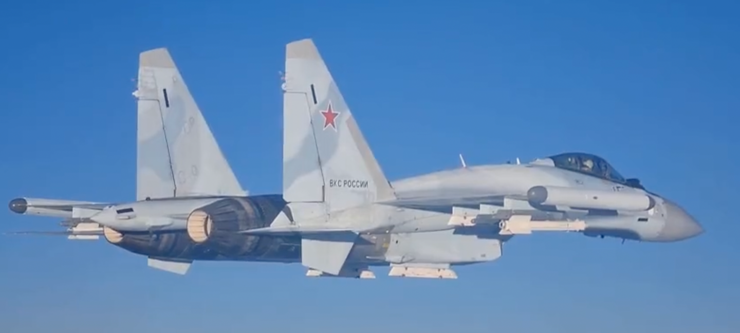 A VKS Su-35S is seen from the cockpit of a Tu-95MS. The fighter jet carries at least two R-73 series (AA-11 Archer) air-to-air missiles. <em>Russian Ministry of Defense screencap</em>