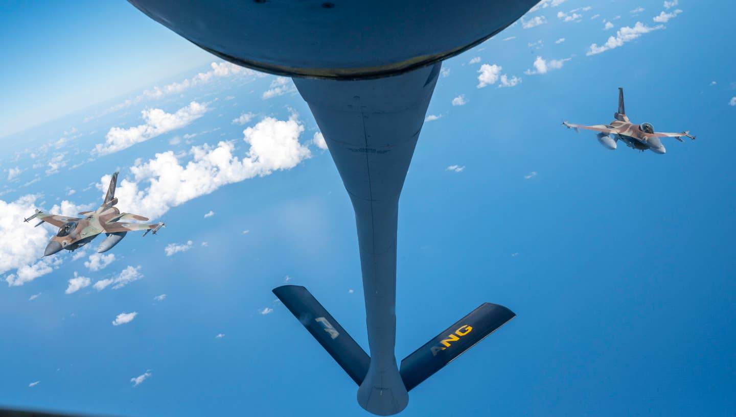 Two IAF F-16C Barak jets in formation behind a U.S. Air Force KC-135 Stratotanker assigned to the 340th Expeditionary Air Refueling Squadron, as part of the bilateral exercise in the U.S. Central Command area of responsibility, November 30, 2022. <em>U.S. Air Force photo by Staff Sgt. Kirby Turbak</em>