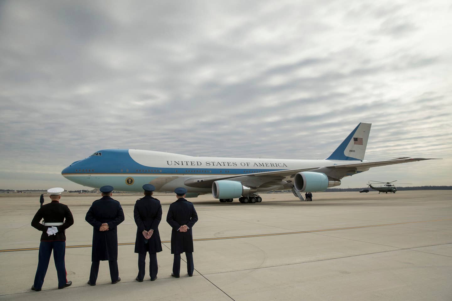 FILE - Military personnel watch as Air Force One, with President Donald Trump, aboard prepares to depart at Andrews Air Force Base in Md., Friday, Feb. 17, 2017. After more than half a century, Boeing is rolling its last 747 out of a Washington state factory on Tuesday night. The jumbo jet, which has been used as a cargo plane, a commercial aircraft capable of carrying nearly 500 passengers and as Air Force One, debuted in 1969. (AP Photo/Andrew Harnik, File)