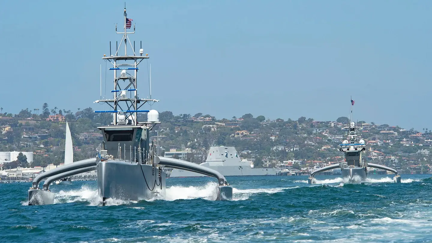 The Navy's Sea Hunter and Seahawk medium-displacement unmanned surface vessels sail together during the Unmanned Integrated Battle Problem 21 experiment in 2021. Task Force 59 oversees operations involving various unmanned platforms. <em>Credit: U.S. Navy</em>