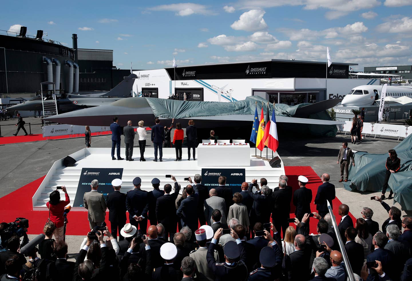 French President Emmanuel Macron; Eric Trappier, Chairman and CEO of Dassault Aviation; Spanish Defence Minister Margarita Robles; French Defence Minister Florence Parly and German Defense Minister Ursula von der Leyen attend the unveiling of a full-scale model of the manned fighter component of the pan-European FCAS, during the Paris Air Show in 2019. <em>YOAN VALAT/AFP via Getty Images</em>