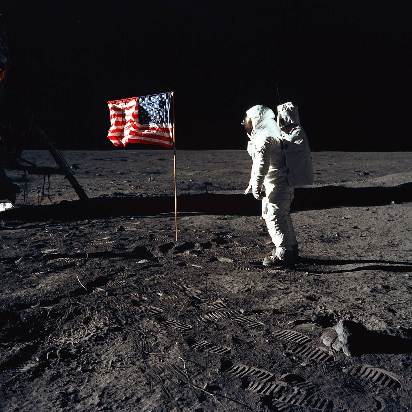 Astronaut Buzz Aldrin, the lunar module pilot of the first lunar landing mission, poses for a photograph beside the deployed United States flag during an Apollo 11 Extravehicular Activity (EVA) on the lunar surface. <em>NASA/Wikimedia Commons</em>