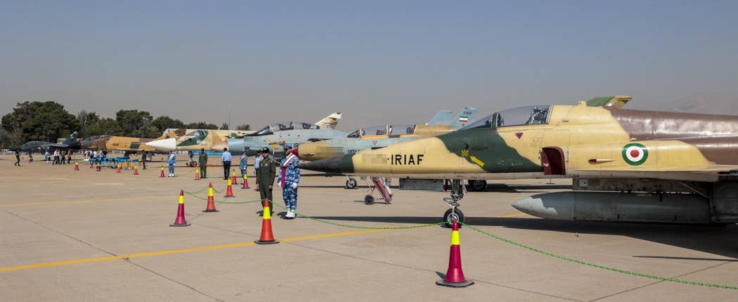 A line-up of Islamic Republic of Iran Air Force jets in September 2022. From front to back: an F-5E Tiger II (or derivative), an FT-7, an F-14A Tomcat, an Su-24 Fencer, an F-4D Phantom II, and a Mirage F1BQ. <em>Fars News via Wikimedia</em>