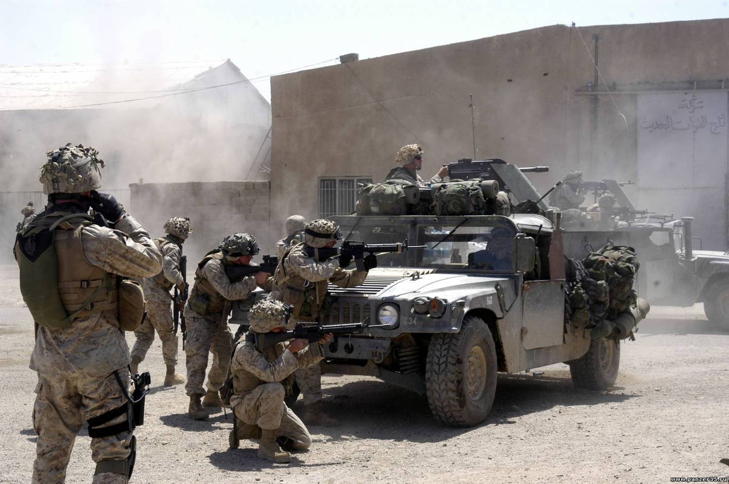U.S. Marines with Company A, 1st Battalion, 5th Marine Regiment. Marine Captain Philip Treglia calls in an airstrike while his Marines fire against terrorists operating in Fallujah on April 7, 2004. <em>Credit: U.S. Marine Corps photo by Cpl. Matthew J. Apprendi/Wikimedia Commons</em>