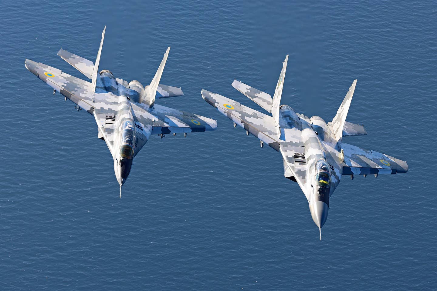 A training flight involving single-seat and two-seat MiG-29s. Juice is flying as lead, with the Ukrainian flag in the cockpit.&nbsp;<em>Yurii Kysil</em>
