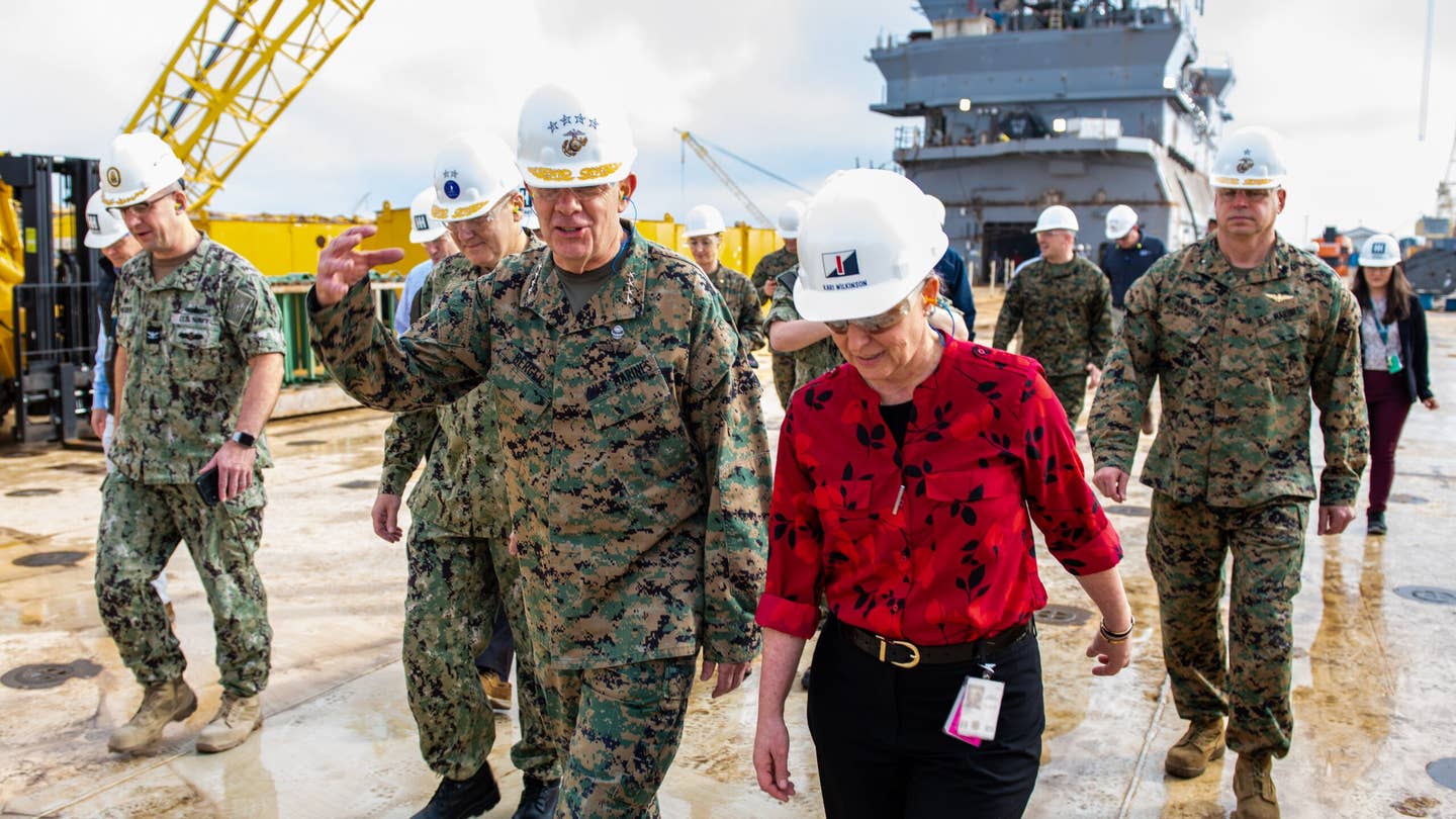 Gen. David Berger, Commandant of the U.S. Marine Corps, visits with Ingalls Shipbuilding leadership while touring the shipyard on Monday, Dec. 12, 2022, where two amphibious ships are currently under construction, <em>Bougainville</em> (LHA 8) and <em>Richard M. McCool Jr.</em> (LPD 29).<em>Credit: HII</em>