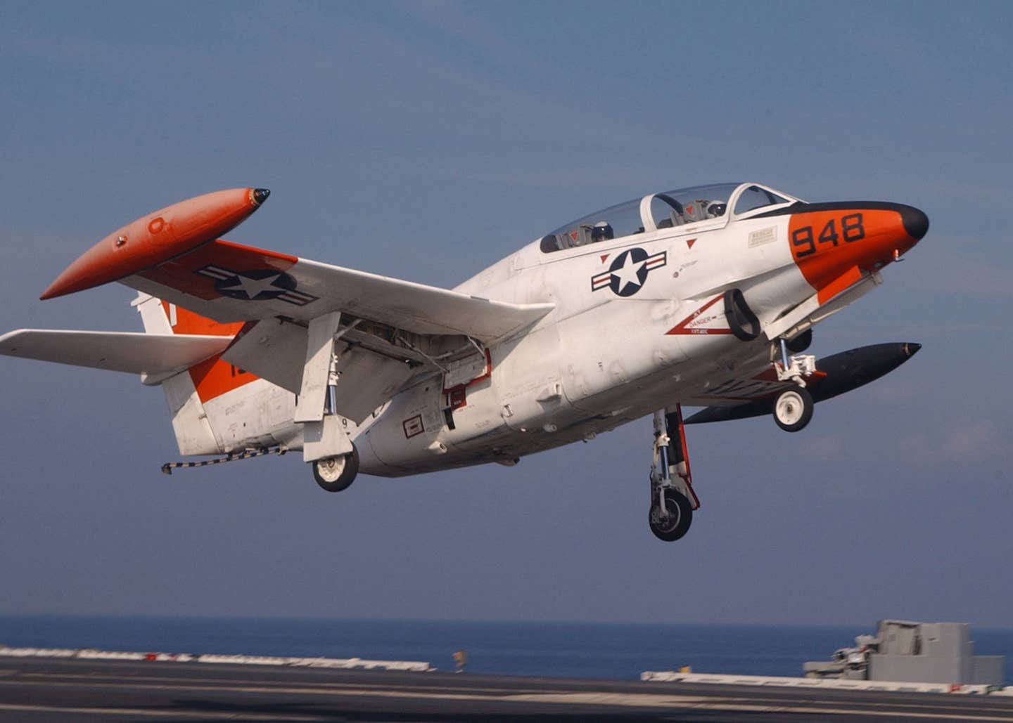 A T-2C Buckeye assigned to Training Squadron Nine (VT-9) performs a touch-and-go on the flight deck of USS <em>Harry S. Truman</em> (CVN-75) in July 2003. This was the last time the Buckeye was used to train student pilots aboard aircraft carriers. <em>U.S. Navy photo by Photographer’s Mate 2nd Class Danny Ewing Jr</em>