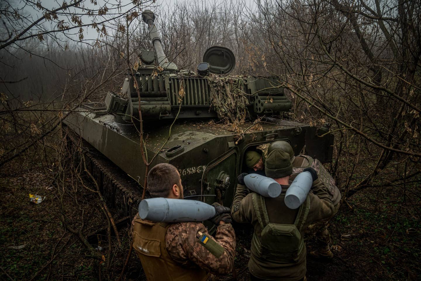Ukrainian artillerymen from the 24th brigade load ammunition inside of a 2S1 Gvozdika self-propelled howitzer at a position along the front line in the vicinity of Bakhmut, Donetsk region. (Photo by Ihor Tkachov / AFP) (Photo by IHOR TKACHOV/AFP via Getty Images)