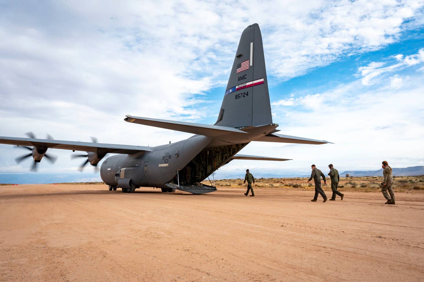 U.S. Airmen from the 40th Airlift Squadron board a C-130J Super Hercules for take-off after simulating refueling from an M1A2 Abrams tank at Fort Bliss. <em>Credit: U.S. Air Force photo by Senior Airman Leon Redfern</em>