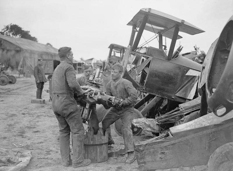 Mechanics removing the engine from a wrecked fuselage at the aircraft repair depot near Rang-du-Fliers, July 12, 1918. <em>David McLellan via Wikimedia Commons</em>