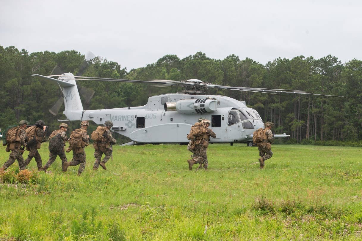 U.S. Marines with 1st Battalion, 2nd Marine Regiment prepare to board a CH-53K King Stallion helicopter for an air assault training exercise at Marine Corps Base Camp Lejeune, North Carolina, June 10, 2021. <em>U.S. Marine Corps photo by Cpl. Yuritzy Gomez</em>