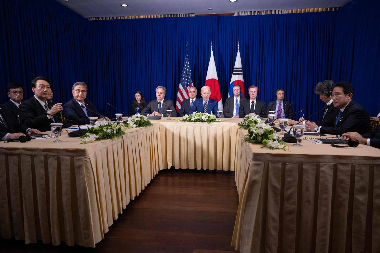 U.S. President Joe Biden (center) meets with Japanese Prime Minister Fumio Kishida (right) and South Korean President Yoon Suk Yeol (left) on the sidelines of the East Asia Summit during the 40th and 41st Association of Southeast Asian Nations (ASEAN) Summits in Phnom Penh on November 13, 2022. <em>Photo by SAUL LOEB/AFP via Getty Images</em>