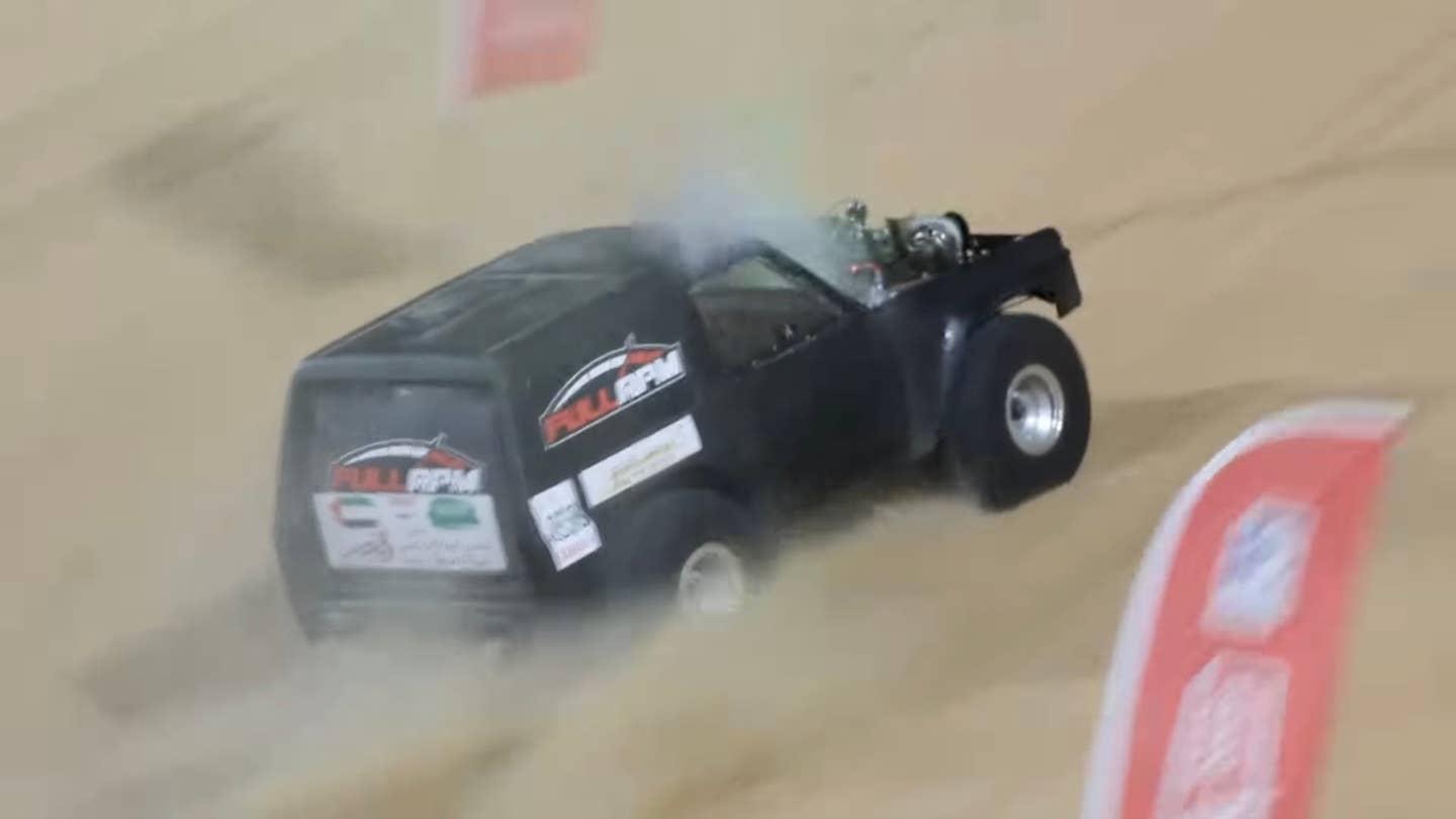 An SUV races up Moreeb Dune
