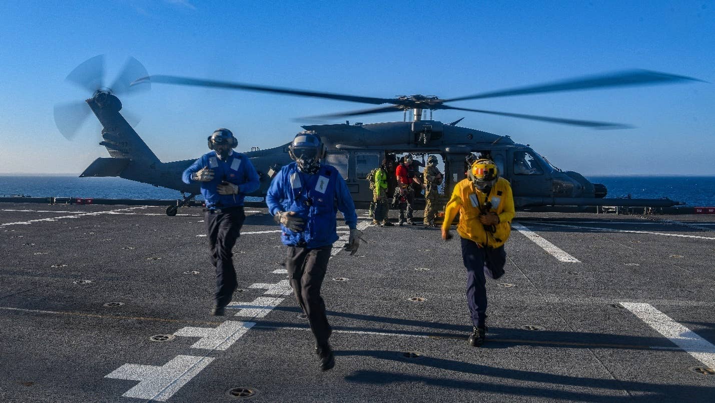 U.S. Navy Sailors depart the landing zone of an HH-60W helicopter. <em>Credit: U.S. Navy photo by Mass Communication Specialist 2nd Class Conner D. Blake/Released</em>