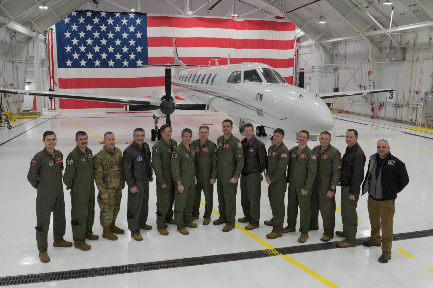 115th Fighter Wing pilots and military information support operators for the Wisconsin Air National Guard’s RC-26B gather with Wisconsin National Guard leadership following the aircraft’s final flight on December 28, 2022. <em>U.S. Air National Guard photo by Senior Master Sgt. Paul Gorman</em>