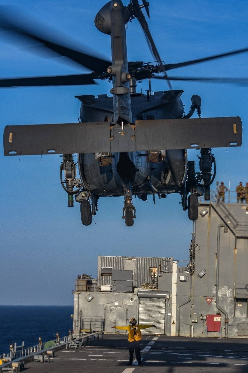 An HH-60W, assigned to the 41st Rescue Squadron, from Moody Air Force Base, Georgia, departs the flight deck of the <em>Lewis B. Puller</em> class expeditionary sea base USS <em>Hershel “Woody” Williams</em> (ESB-4), in the Indian Ocean, December 31, 2022. <em>U.S. Navy photo by Mass Communication Specialist 2nd Class Conner D. Blake/Released</em>