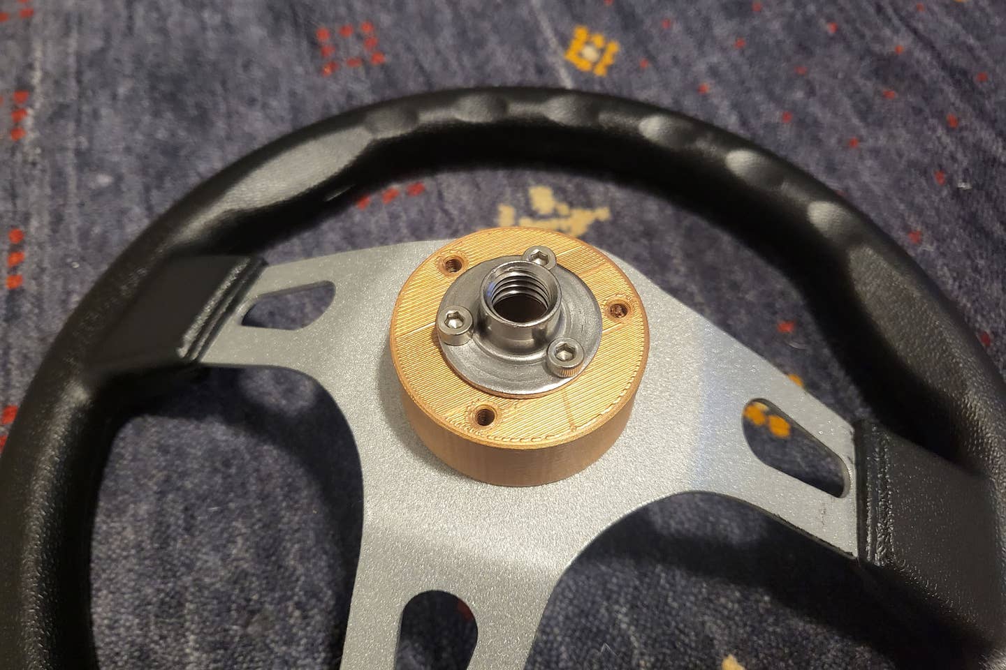 The only 3D-printed part of the kart is the steering adapter, which allows the wheel to bolt up to the smaller screw-mount nuts I used for most of the steering.