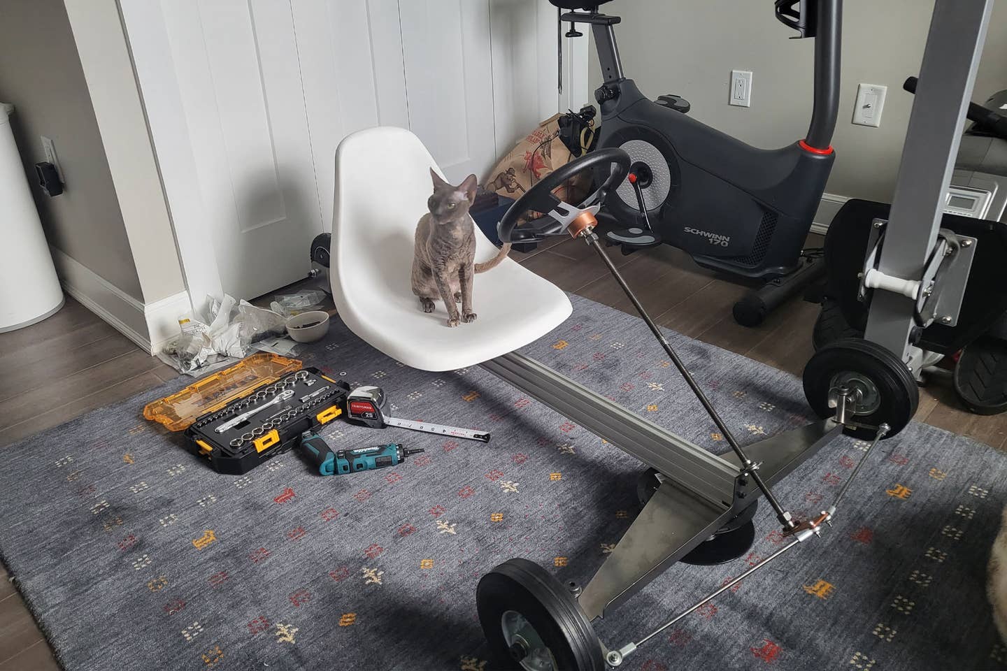This is a picture of an early version of the kart which illustrates what kind of space I had to work in. Not much. Also visible is a 3D-printed mockup of a pitman arm that didn't work and the aforementioned $0.87 steering links, which have given me no trouble. This front axle was way too weak, and the single steering support was not adequate. <em>Peter Holderith</em>