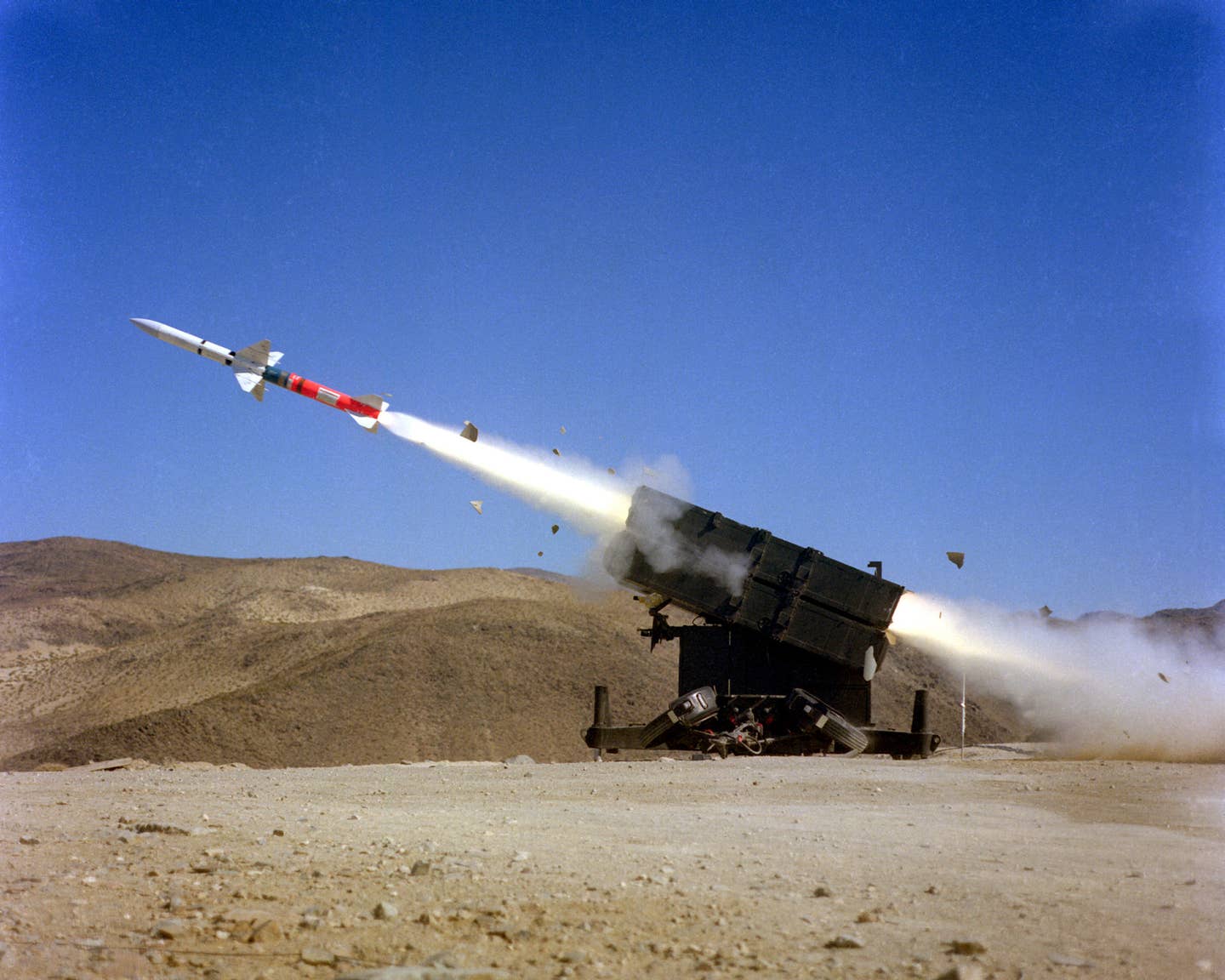 A left side view of an AIM-7F Sparrow III air-to-air missile being launched from a Skyguard missile launcher. <em>DoD</em>
