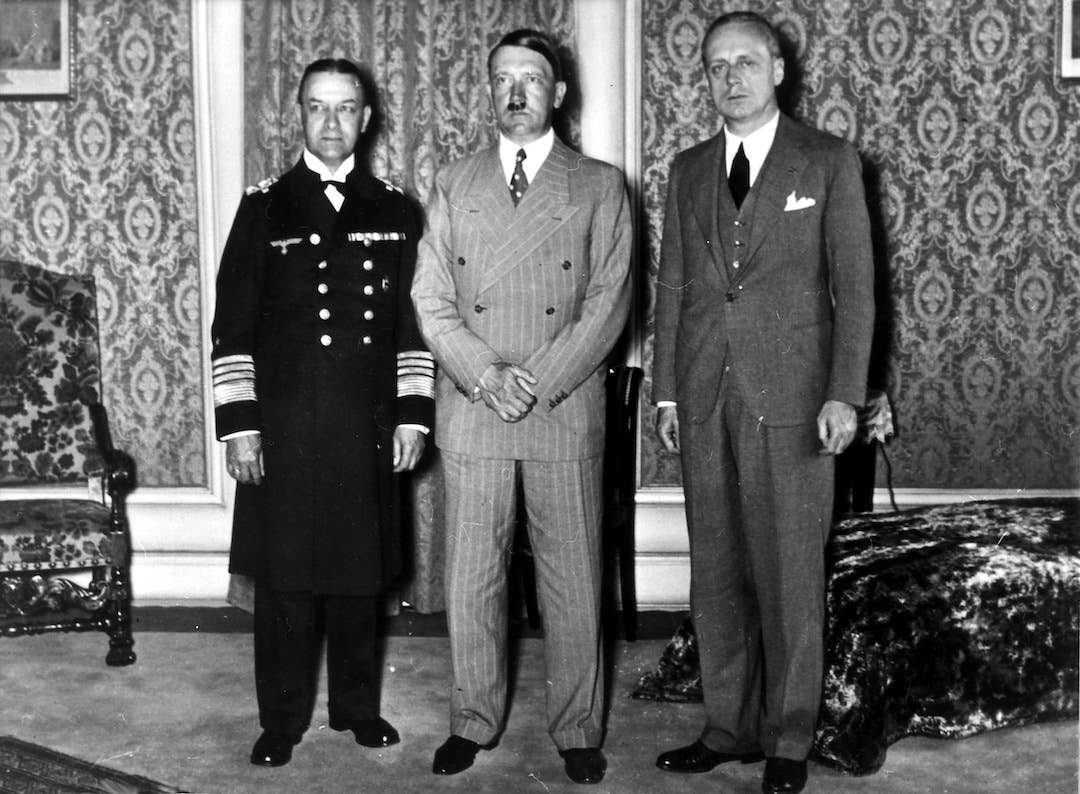 Adolf Hitler receives Ambassador Joachim von Ribbentrop in Berlin (right), the head of the German delegation sent to London to negotiate the Anglo-German Naval Agreement, after the agreement's signing, June 23, 1935. On the left, Admiral Erich Raeder. <em>Photo by Heinrich Hoffmann/Ullstein Bild via Getty Images</em>