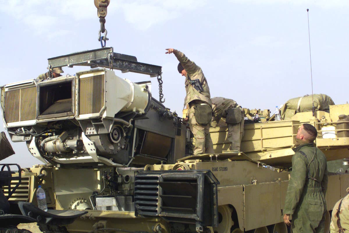 Marines remove the Full-Up Power Pack (FUPP), which includes the AGT1500 gas turbine engine and other components, from an Abrams tank. <em>USMC</em>