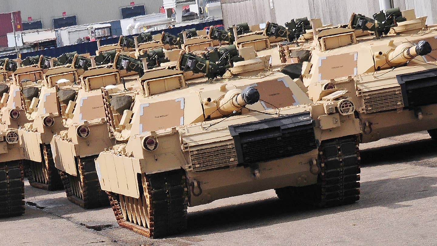A group of M1 Abrams tanks sit in a holding area after being offloaded from the freighter ship “Resolve” at the port of Antwerp April 24. The third-generation battle tanks will move onward to Coleman Barracks in Mannheim, Germany, and will become part of the European Activity Set, a combined-arms group of vehicles and equipment that are pre-positioned in Europe to outfit U.S Army regionally aligned forces when they rotate into Europe for training or contingency operations.  (Photo by Staff Sgt. Warren W. Wright Jr., 21st TSC Public Affairs)