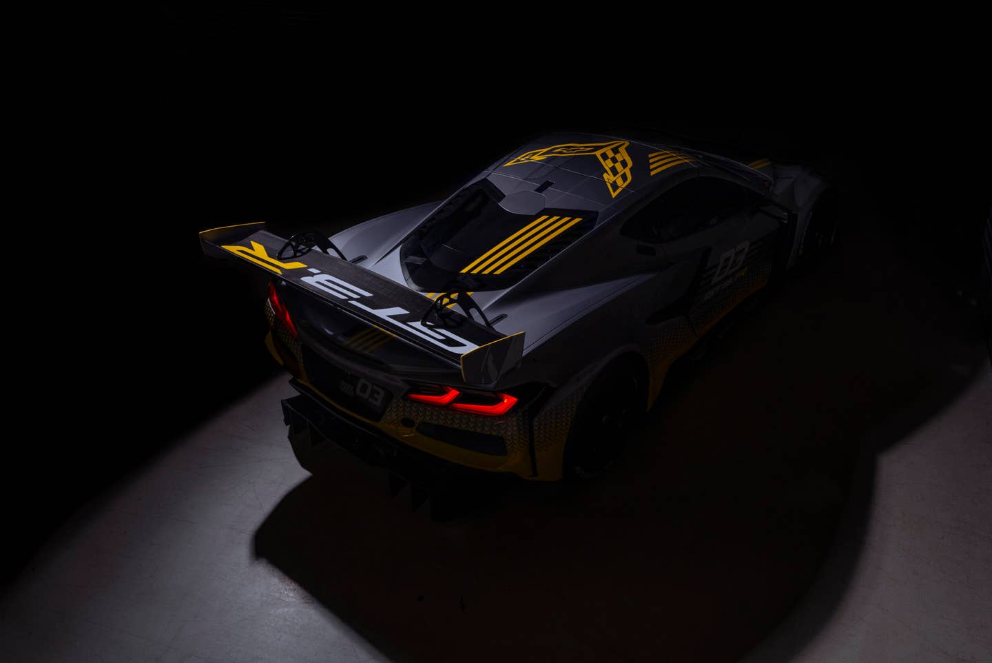 Overhead view of rear three-quarter on 2024 Chevrolet Corvette Z06 GT3.R in spotlight. Pre-production model shown. Actual production model may vary. Model year 2024 Corvette Z06 GT3.R will be available later this year.