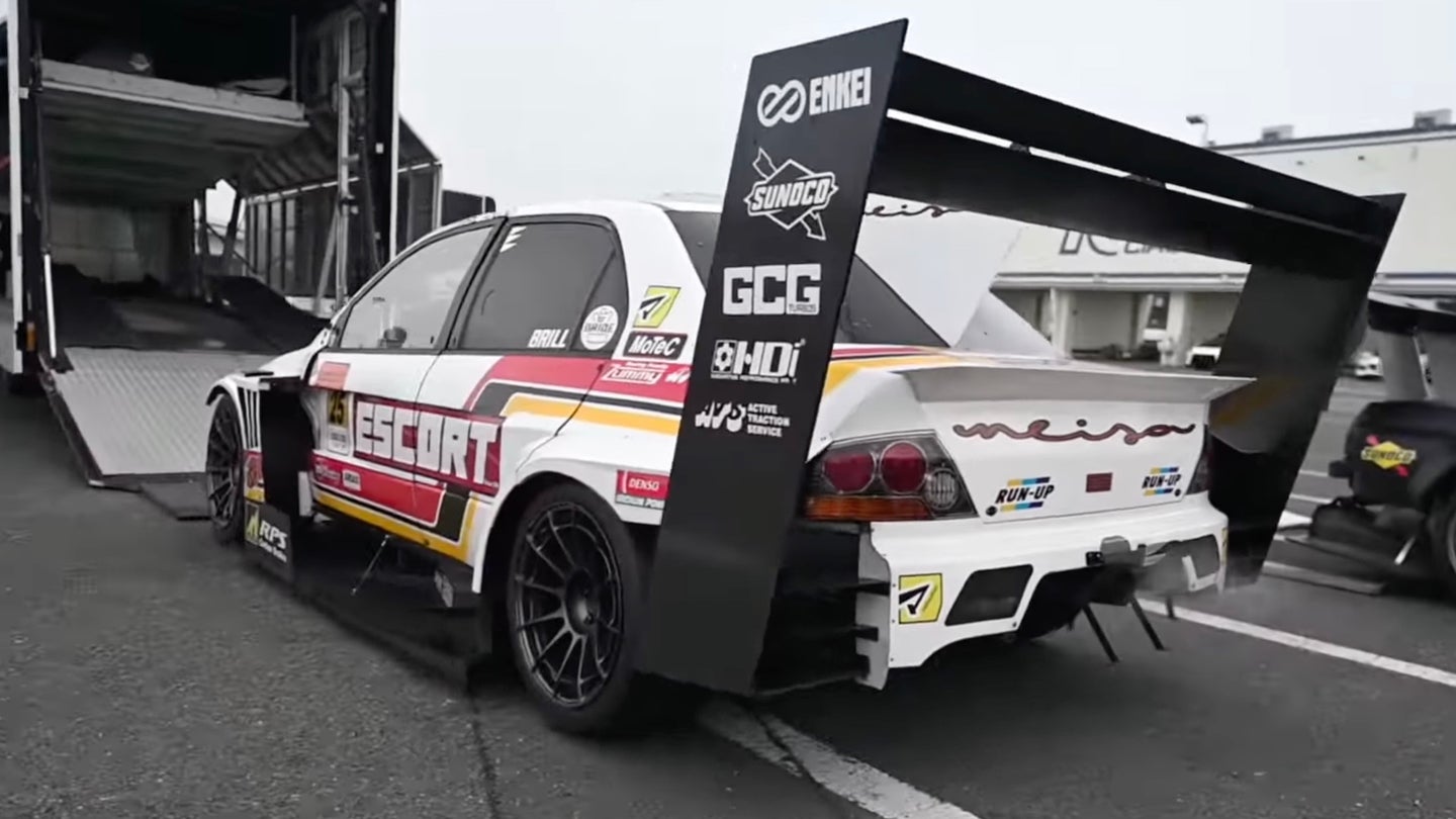 Escort Racing's Mitsubishi Lancer Evolution IX time attack race car being loaded onto a truck