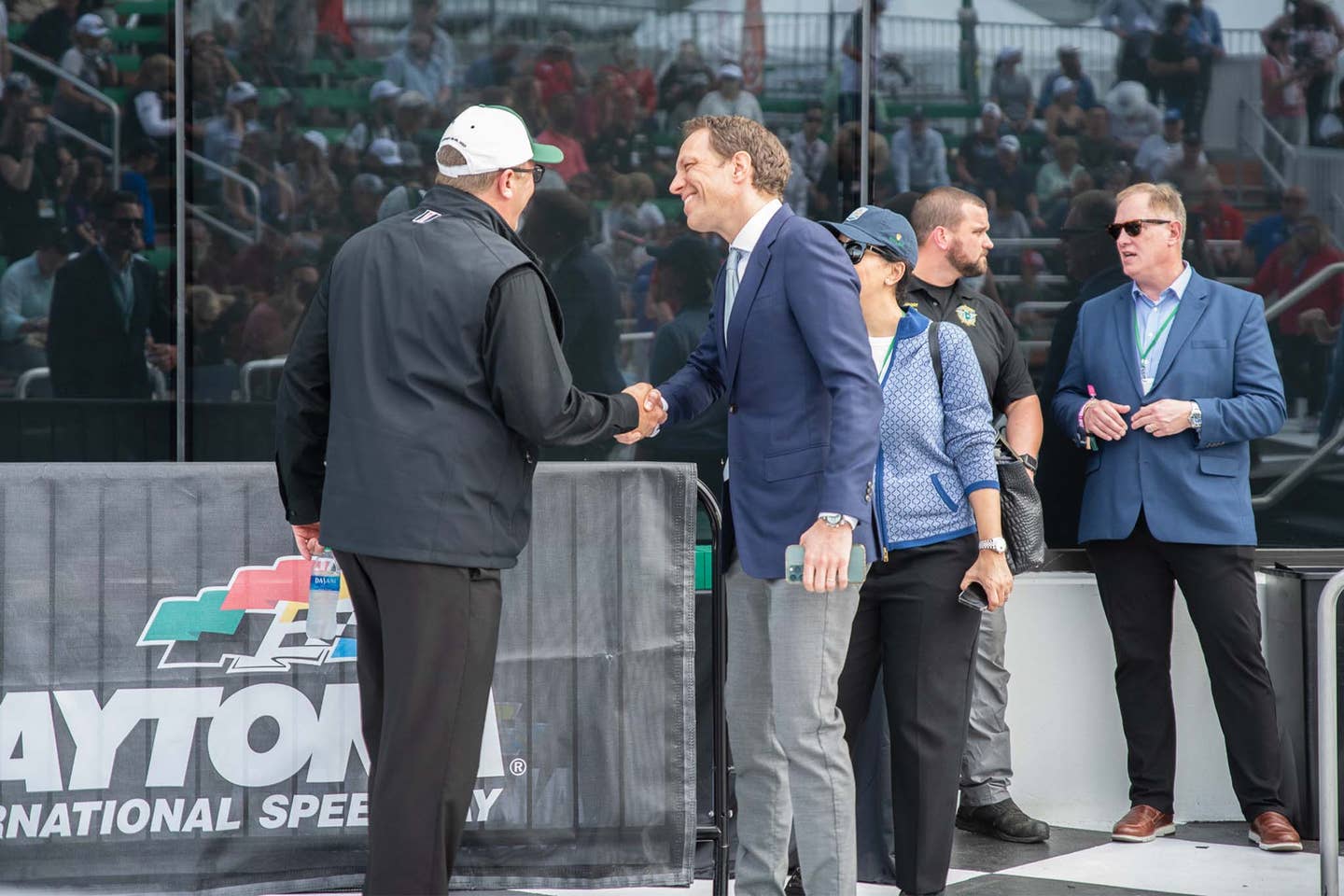 IMSA President John Doonan (left) shakes hands with Rolex USA President and CEO Luca Bernasconi (right) in victory lane at the 2023 Rolex 24.