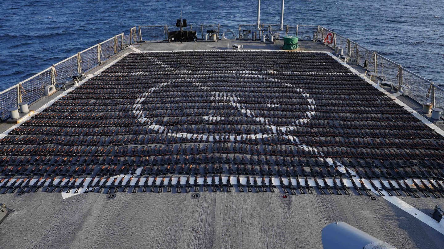 Guns that had been headed to Yemen from Iran that were captured during a counter-smuggling operation in the Gulf of Oman on January 6, 2023, are displayed on the stern flight deck of the U.S. Navy's <em>Arleigh Burke</em> class destroyer USS <em>The Sullivans</em>. <em>CENTCOM</em>