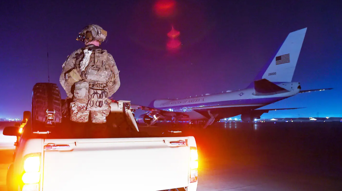 A U.S. special operations forces member stands in a modified pickup truck to help provide security for President Donald Trump’s movements around Bagram Air Base in Afghanistan in 2019.&nbsp;<em>OLIVIER DOULIERY/AFP via Getty Images</em>