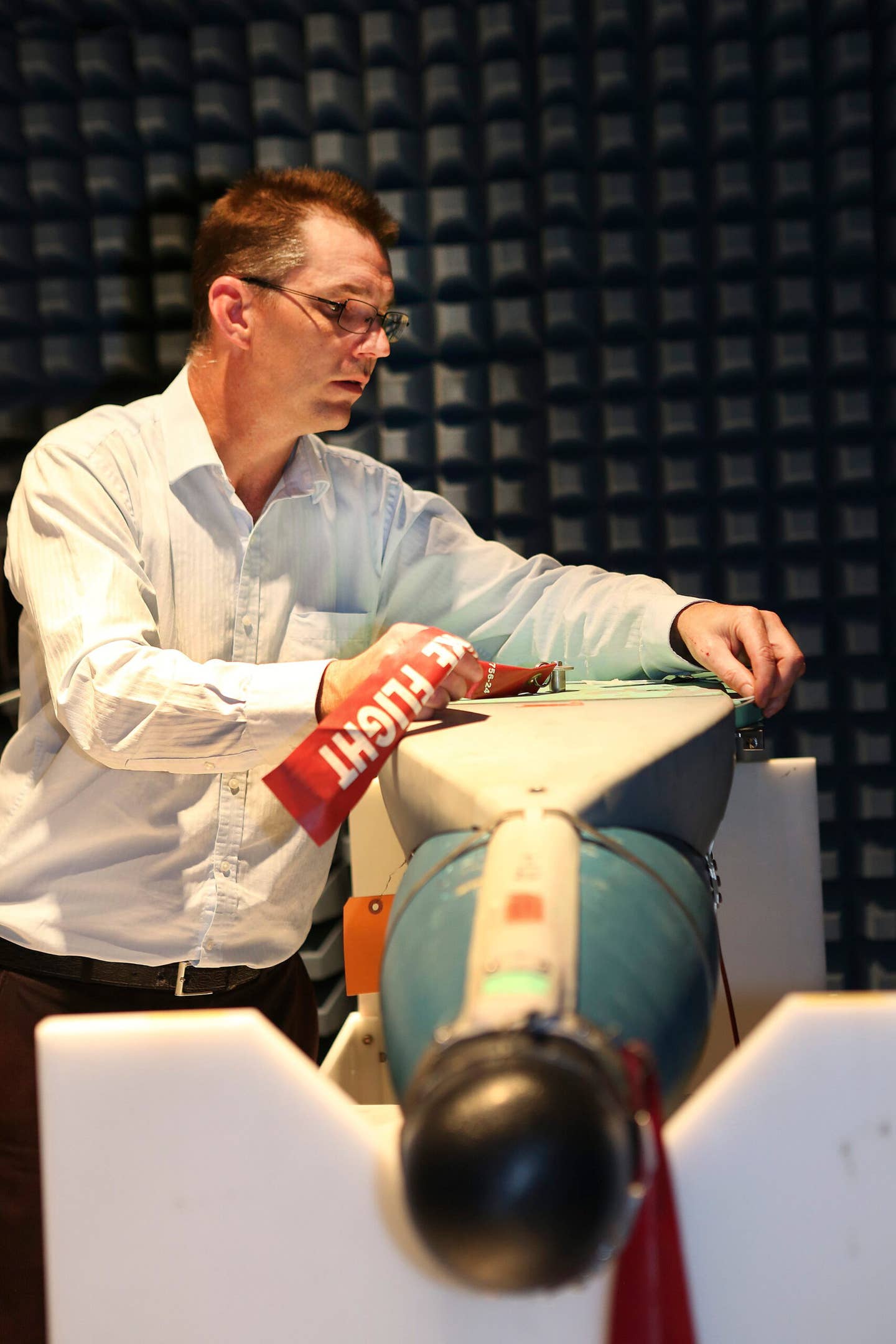 Adjustments are made to a JDAM-ER during evaluation in an anechoic chamber. <em>Australian Defense Force</em>