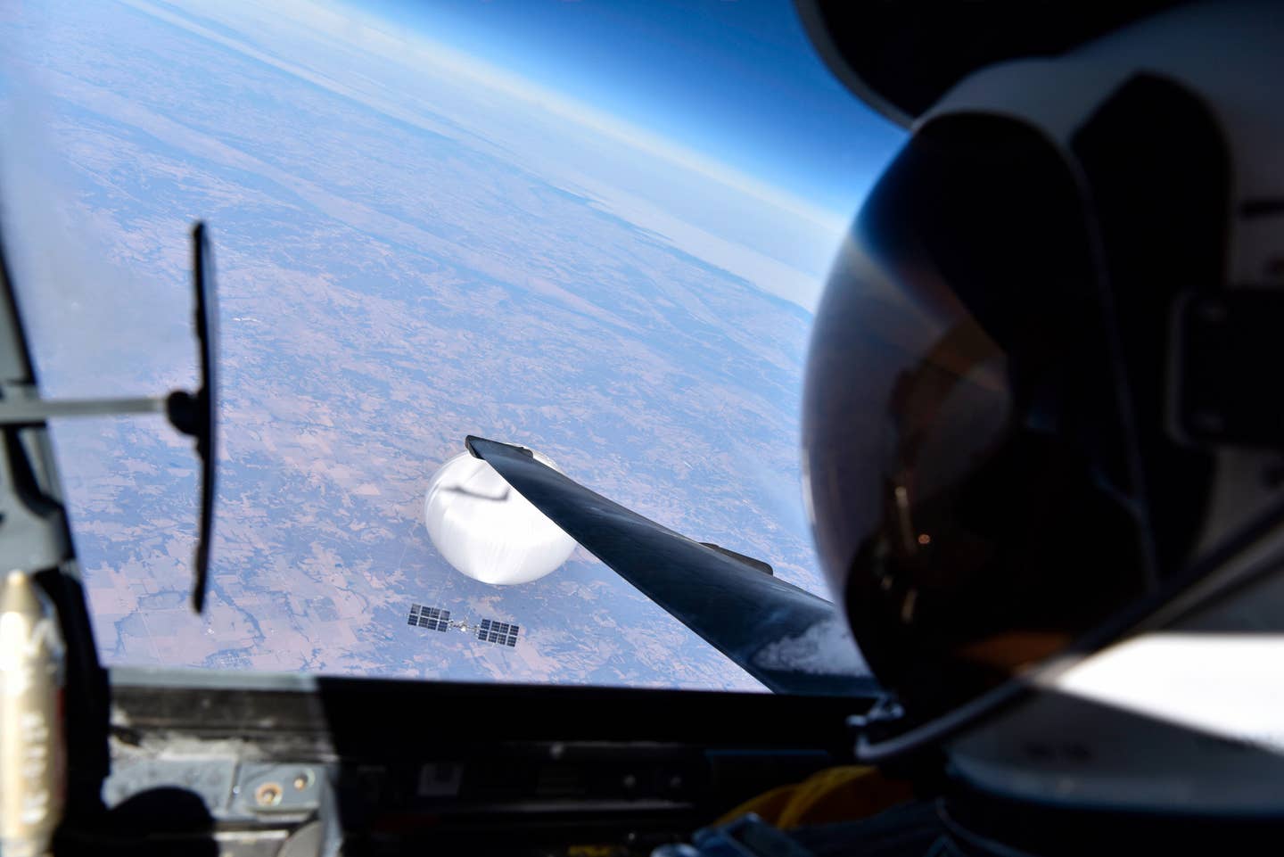 The official caption to this image reads: "A U.S. Air Force pilot looked down at the suspected Chinese surveillance balloon as it hovered over the Central Continental United States February 3, 2023." <em>DOD</em>