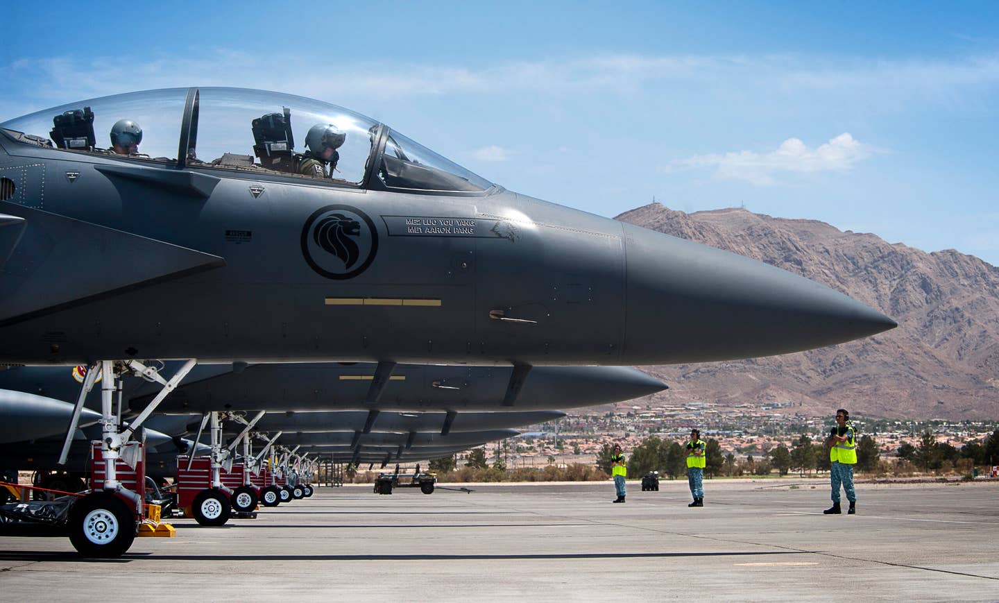 Republic of Singapore Air Force aircrew and crew chiefs prepare to launch three F-15SG aircraft during Red Flag 14-3, in July 2014 at Nellis Air Force Base, Nevada. <em>U.S. Air Force photo by Lawrence Crespo</em>